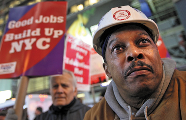 Low-wage workers rally for better pay in Times Square.