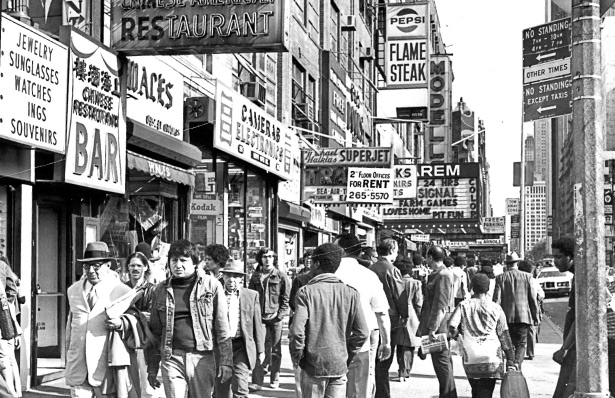 Shoppers hustle down 42nd Street in 1975.
