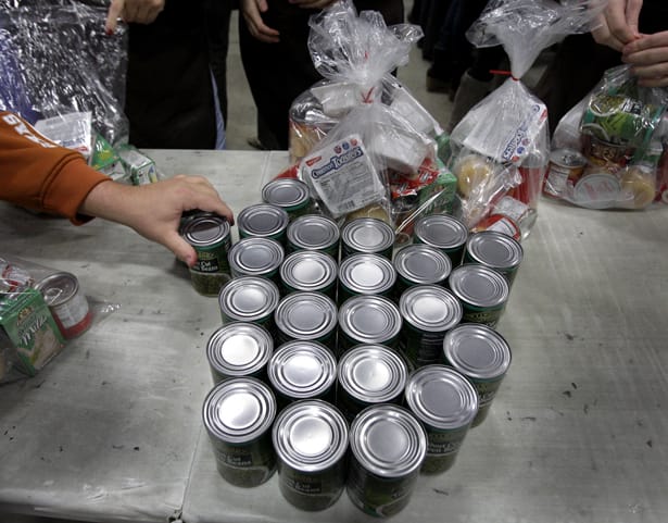 Volunteers-fill-bags-with-food-for-part-of-their-backpack-school-lunch-program-AP-PhotoAmy-Sancetta