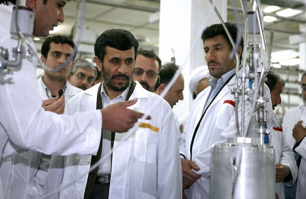 Former-Iranian-President-Mahmoud-Ahmadinejad-center-listens-to-a-technician-during-his-visit-of-the-Natanz-Uranium-Enrichment-Facility.-AP-Photo