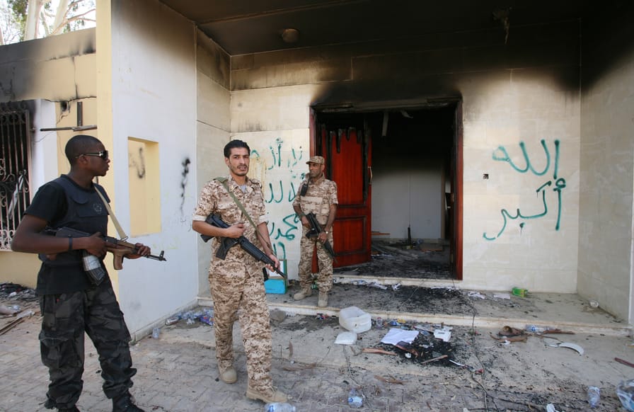 Libyan-military-guards-check-one-of-the-U.S.-Consulates-burnt-out-buildings-during-a-visit-by-Libyan-President-Mohammed-el-Megarif.-AP-Photo