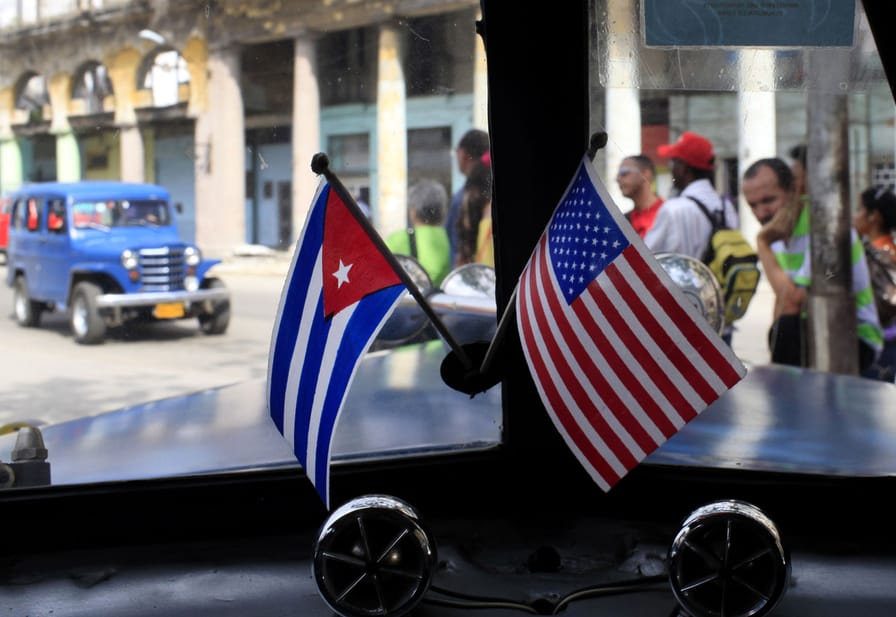 Miniature-flags-representing-Cuba-and-the-US-are-displayed-on-the-dash-of-a-car-in-Havana-Cuba.-AP-PhotoFranklin-Reyes