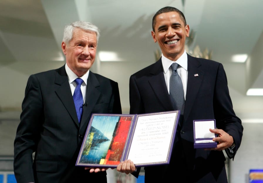 President-Obama-poses-with-his-nobel-medal-and-certificate-while-standing-by-Nobel-Chairman-Thorbjoern-Jagland.-ReutersBjorn-Sigurdson