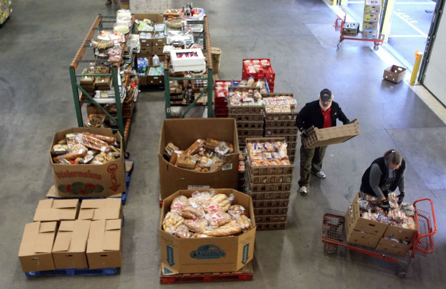 pVolunteers-prepare-food-for-distribution-at-a-New-Hampshire-food-bank.-AP-ImagesJim-Colep