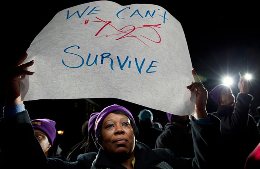 pDarlene-Handy-of-Baltimore-holds-up-a-sign-during-a-rally-to-support-raising-the-minimum-wage-in-Maryland.-AP-PhotoJose-Luis-Magana-nbspp