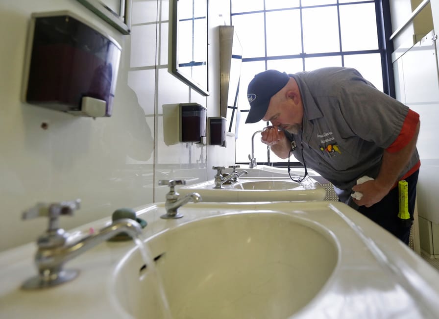 An-inspector-tests-the-water-of-the-first-floor-of-the-State-Capitol-in-Charleston-WV.-Monday-Jan.-13-2014.-AP-PhotoSteve-Helber