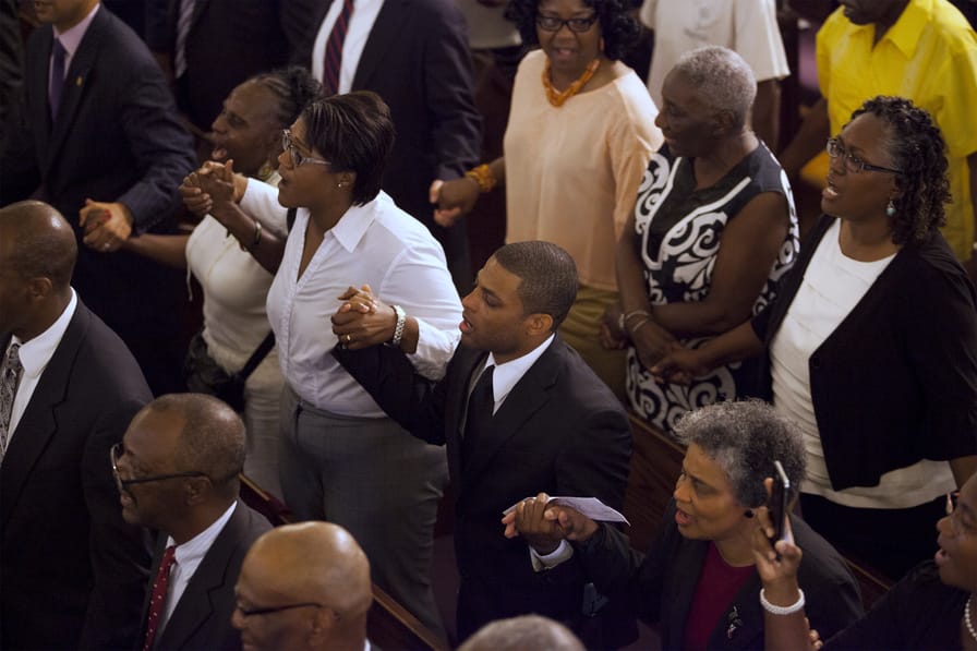 The congregation holds hands during a prayer service for Wednesday's shooting victim held at the Morris Brown AME Church in Charleston