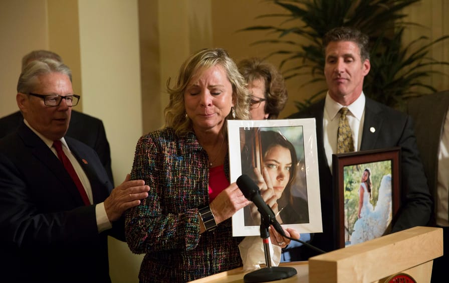 Debbie Ziegler holds a photograph of her daughter, Brittany Maynard, as she talks to the media in Sacramento, CA.