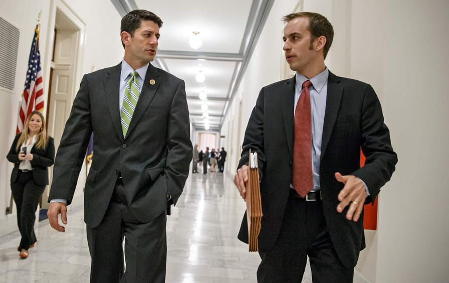 Paul Ryan confers with an aide.
