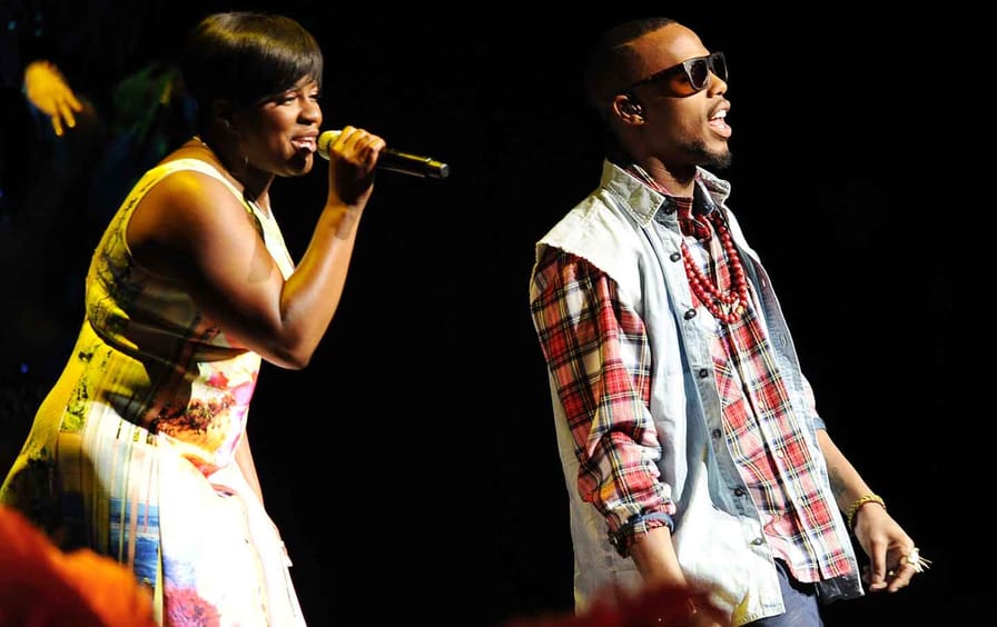 Ester Dean (left) and B.o.B. perform at CinemaCon, March 27, 2014.
