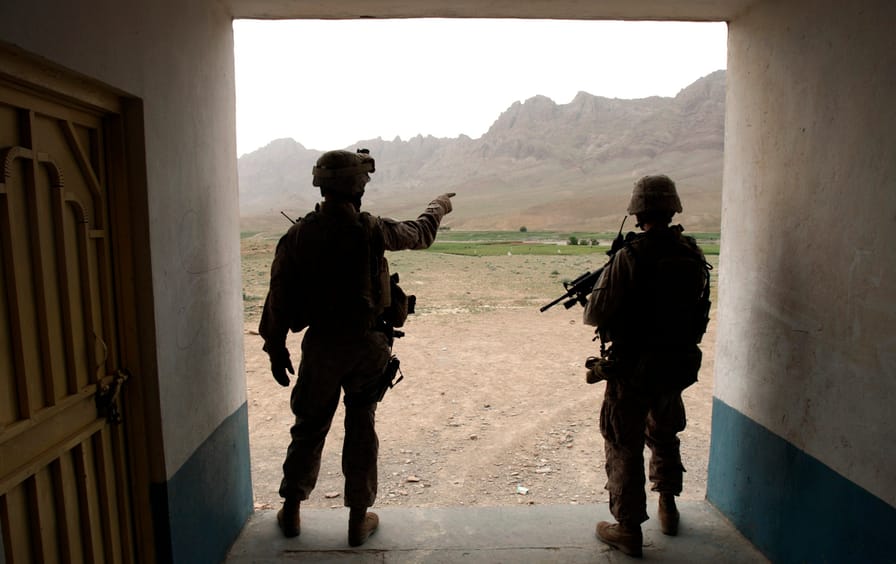 U.S Marines observe an area from a school building during a patrol at a village in the Golestan district of Farah province