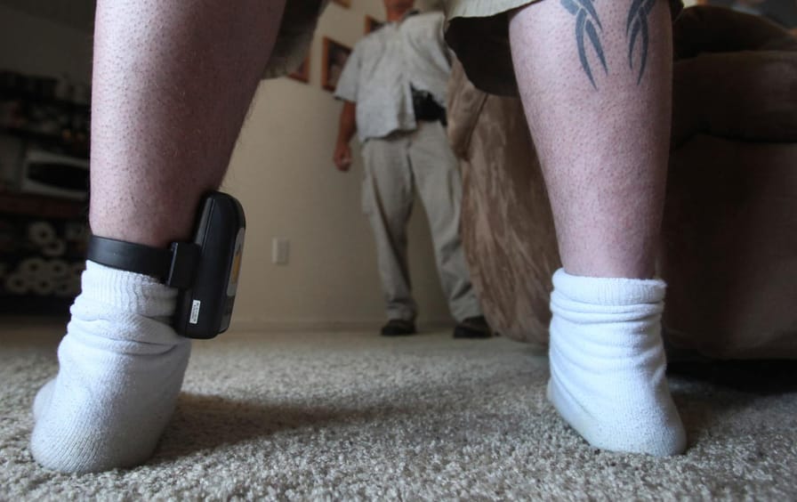 A California parolee wears a GPS tracking device on his ankle.