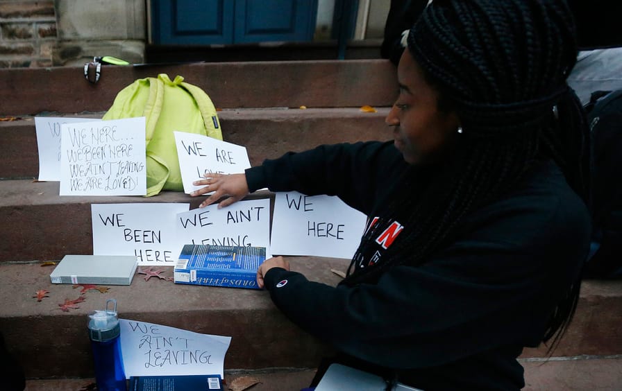 A student shows signs made for a sit-in to demand a range of changes to improve the social and academic experience of black students, at Princeton University, Wednesday, Nov. 18, 2015, in Princeton, N.J.