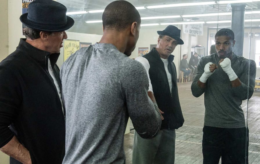 Sylvester Stallone (left) as Rocky Balboa and Michael B. Jordan as Adonis Johnson in Creed.