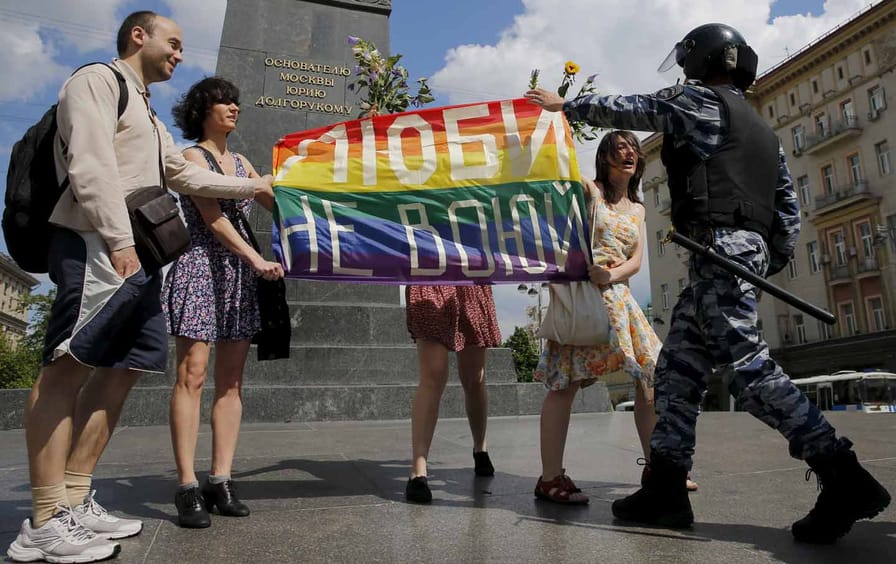 LGBT community rally participants encounter a policeman