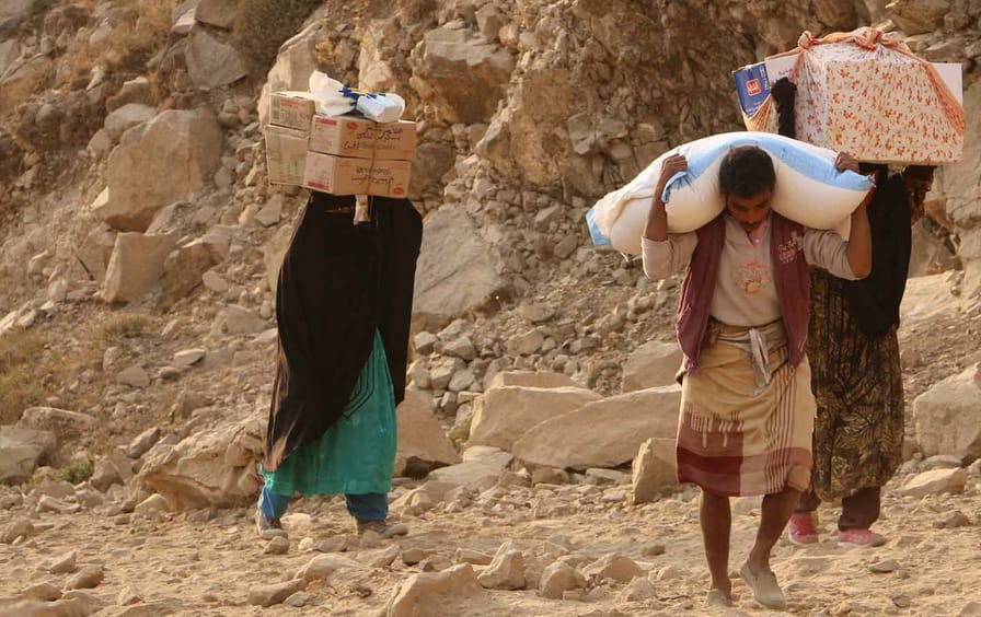 Yemenis carry relief supplies