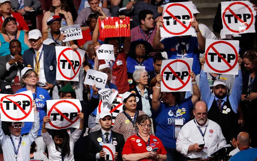 TPP protestors hold signs