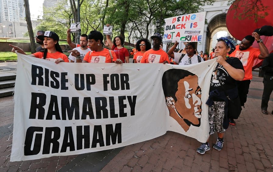 Protestors arrive at One Police Plaza in support of the family of Ramarley Graham Thursday, June 2, 2016, in New York. The mother of Graham, an unarmed black teenager fatally shot by a white policeman in front of his grandmother and young brother joined supporters Thursday for a 17-mile march to police headquarters to demand that the officers involved in the 2012 slaying be fired.