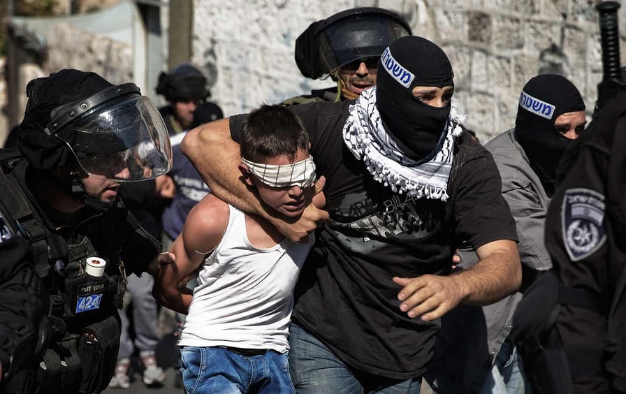 A Palestinian child is taken by Israeli police in Jerusalem