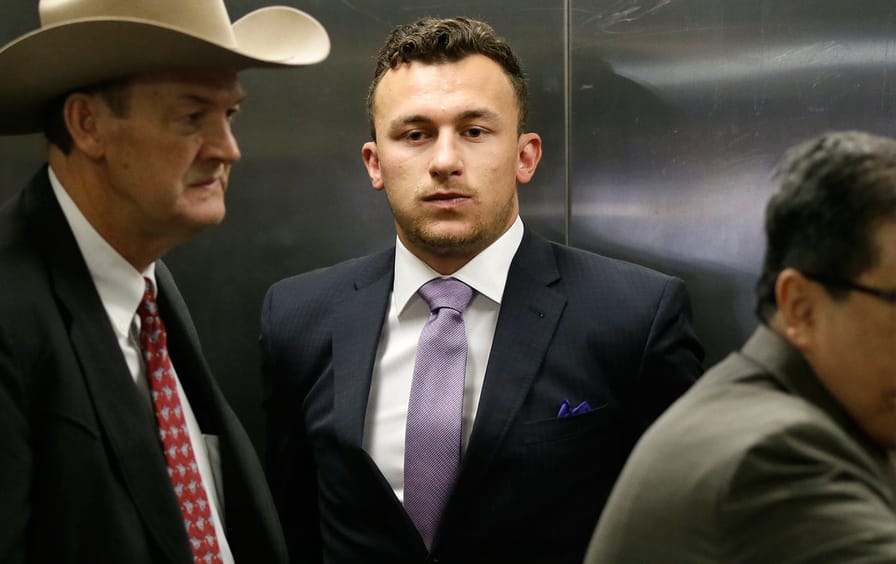 Former NFL quarterback Johnny Manziel takes an elevator with his lawyer Jim Darnell in Dallas on Tuesday, February 28, 2017.