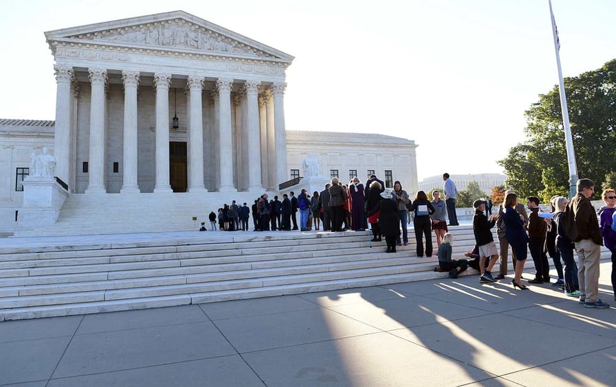 People wait outside the Supreme Court