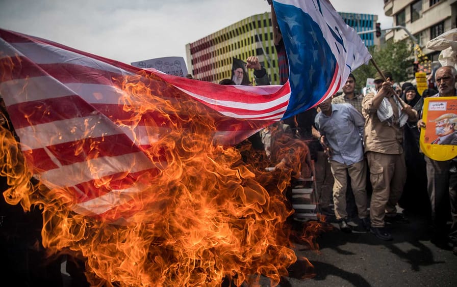 Iranian protesters burn US flag
