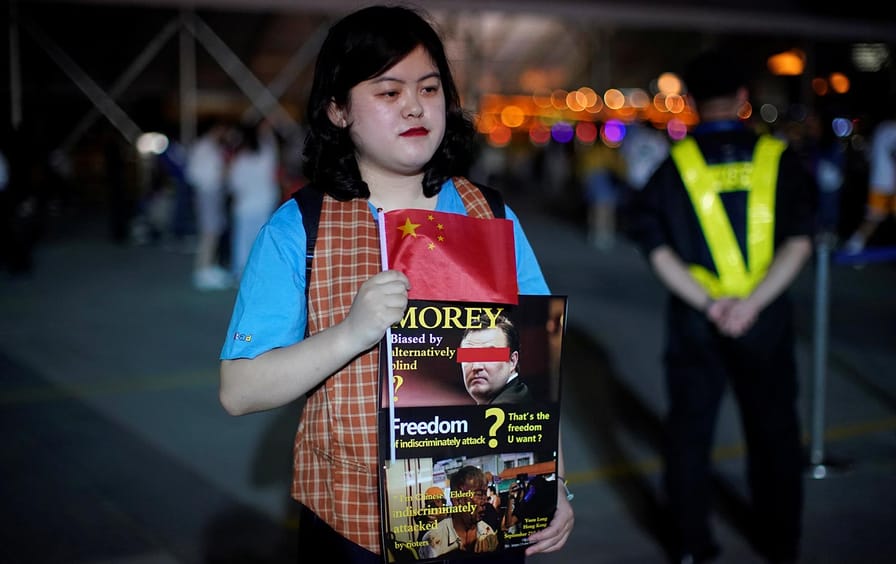 Woman in China holds sign showing Morey