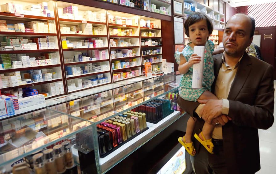 An Iranian man and child in a drugstore, 2018