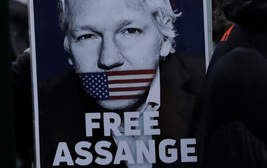 Poster of Julian Assange that says 