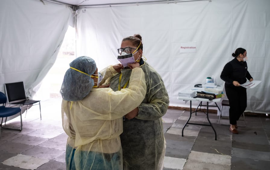 Nurses adjust protective masks