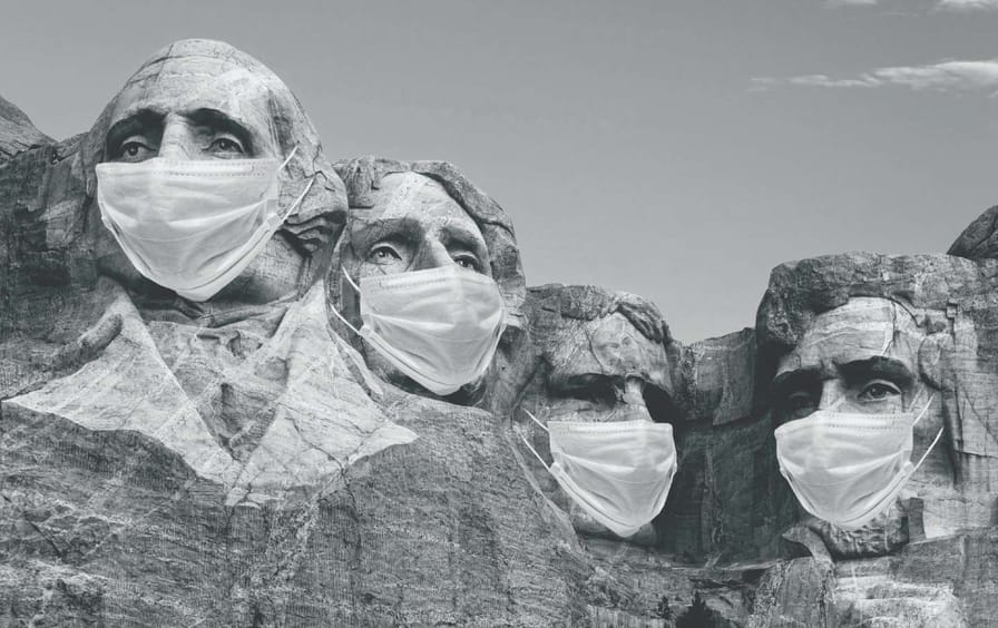 The faces on Mt. Rushmore wearing surgical masks