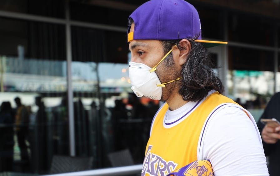 A Lakers fan wears a protective mask