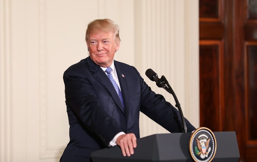 President Donald Trump stands at a podium