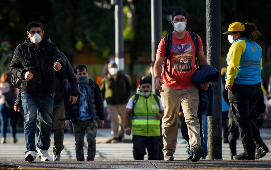 Pedestrians wear face masks while walking