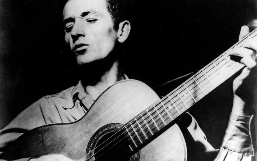 woody-guthrie-guitar-playing-ap-img