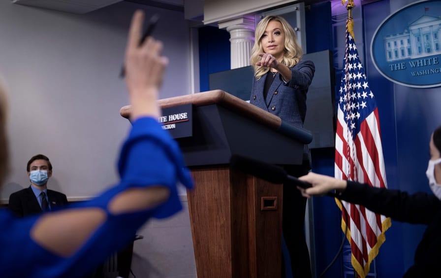 Kayleigh McEnany pointing at a person with their hand raised