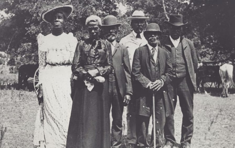 Black men and women dressed for an emancipation day celebration in Texas