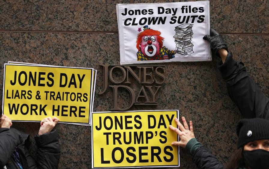 Protest signs in front of Jones Day office