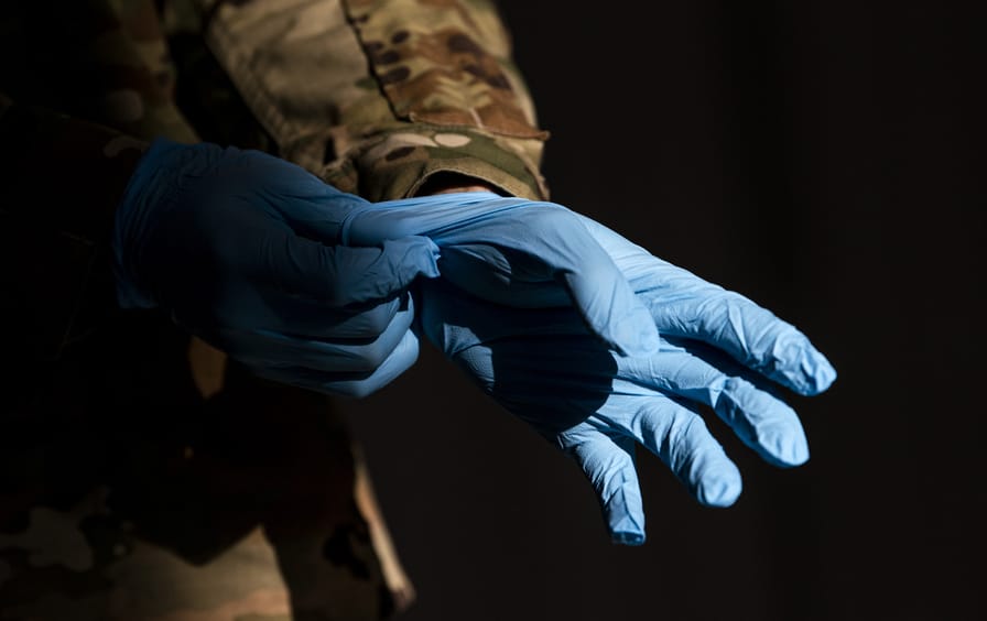 military-uniform-gloves-covid-testing-gty-img