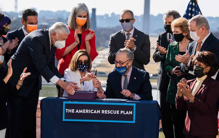 Speaker Nancy Pelosi and Majority Leader Chuck Schumer sign the American Rescue Plan Act.