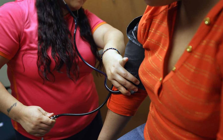 A medical assistant takes a patient's blood pressure
