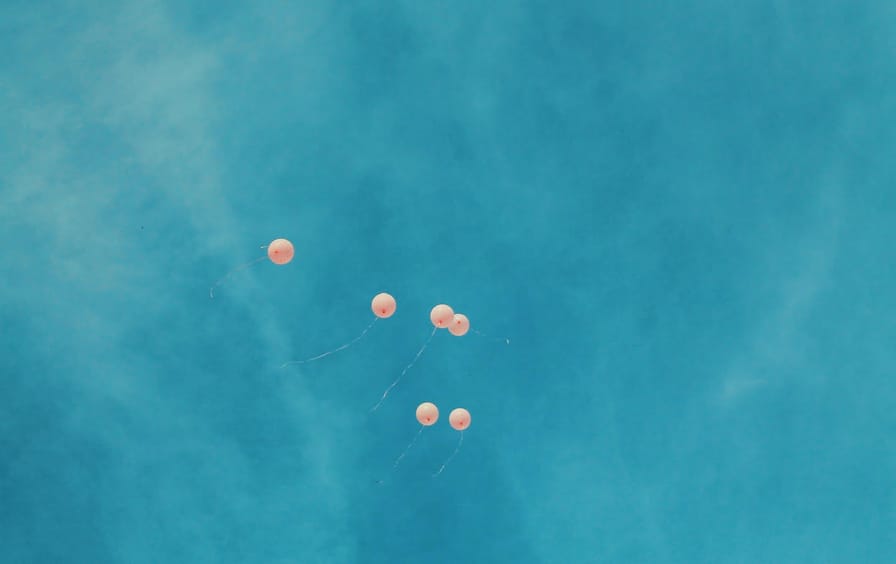 balloons floating in sky
