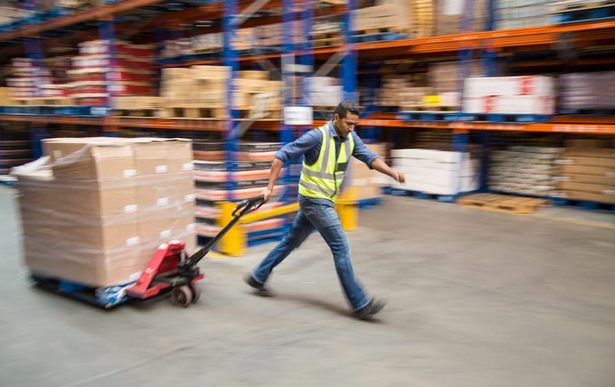Worker inside a food distribution warehouse - stock photo