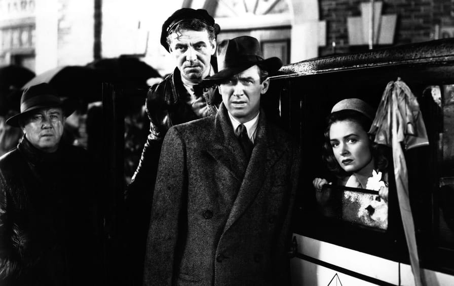 James Stewart as George Bailey and Donna Reed as Mary Hatch and Frank Faylen as Ernie in It's a Wonderful Life
