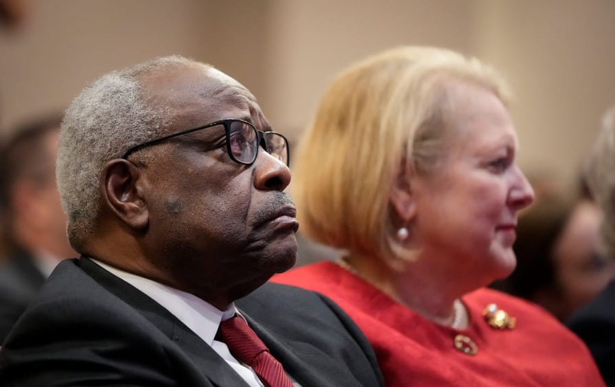 Clarence Thomas and his wife look into the distance