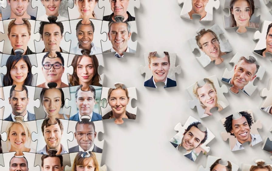 People of different backgrounds fit together as part of a half-completed puzzle