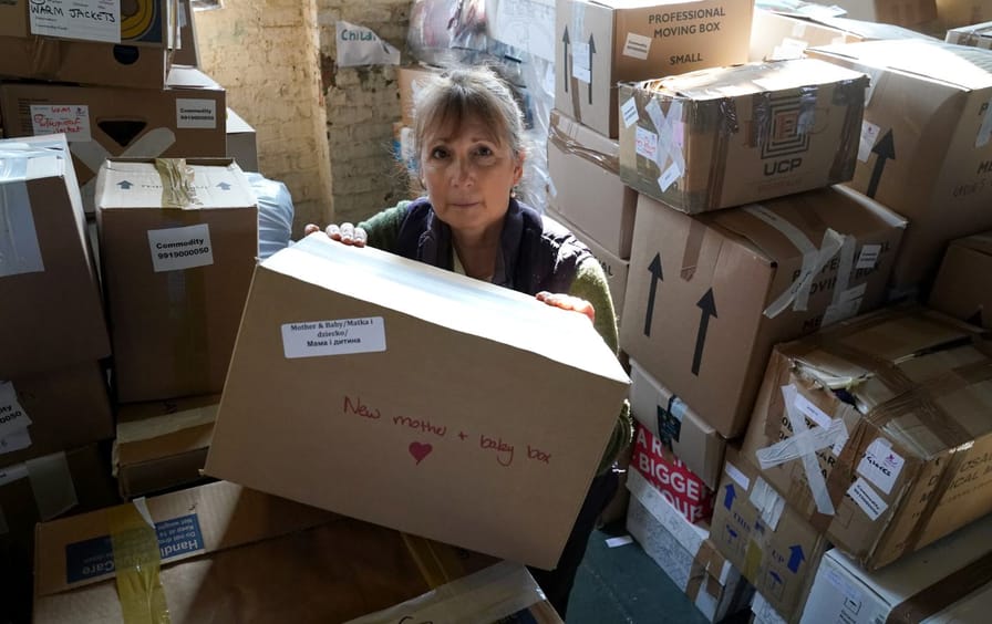 A woman sits in the midst of packages