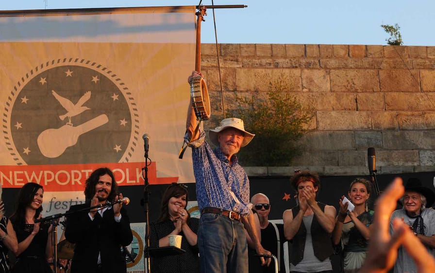 ( Newport, RI )92 yr. old Pete Seeger waves farewell to the audience at conclusion of the Festival.  2011 Newport Folk Festival Sunday, July 31, 2011.  Staff Photo by Arthur Pollock