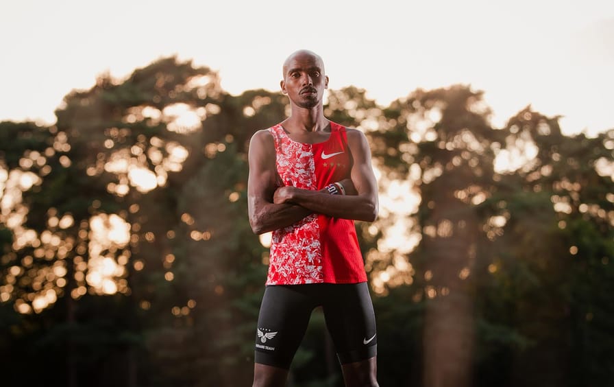 Mo Farah standing with his arms crossed