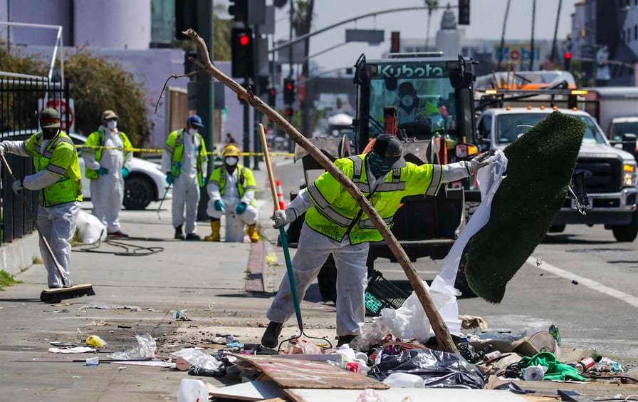 An LA Sanitation Bureau crew cleans up a homeless encampment